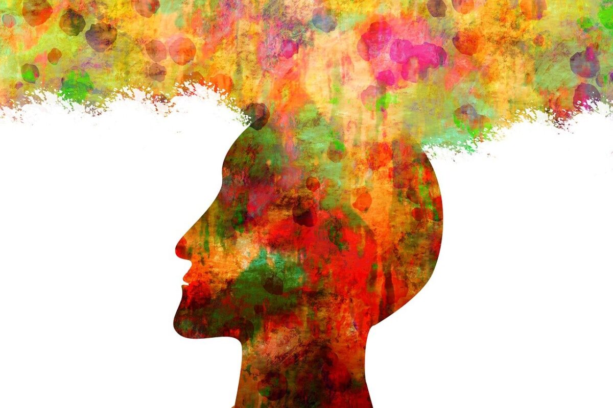 Silhouette of a head with colorful abstract patterns symbolizing gamma brain wave activity.