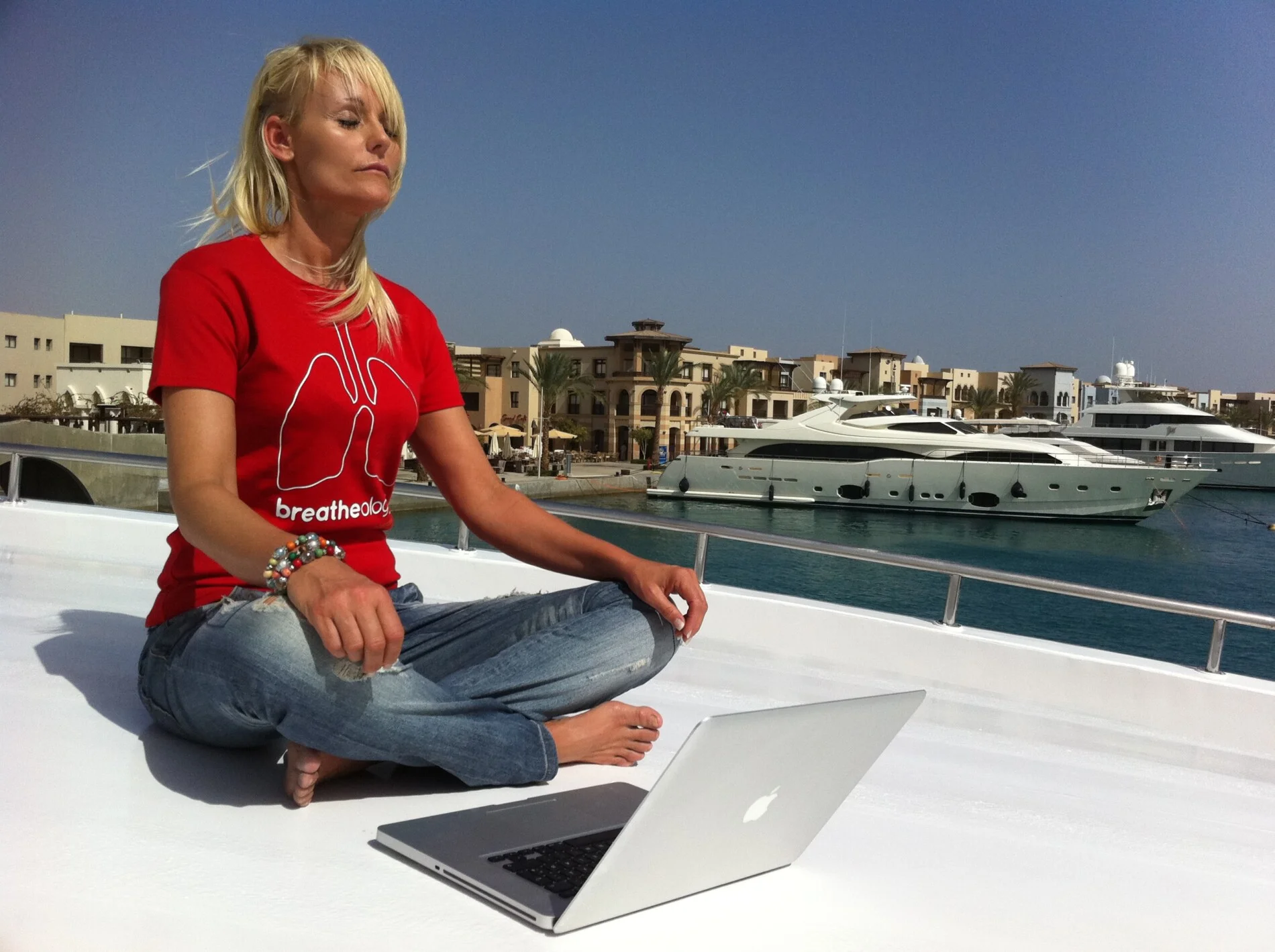 Woman in red Breatheology shirt doing mindful meditation for relaxation and stress relief
